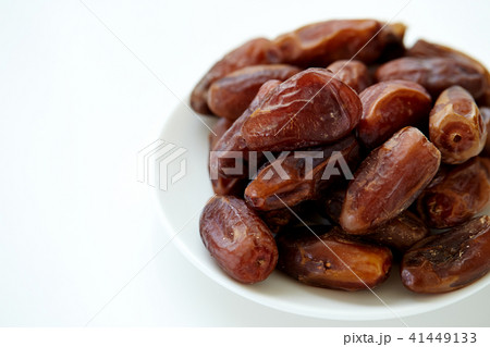 Bowl of dried dates isolated on white backgroun Bowl of dried dates isolated on white backgroun 41449133