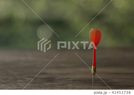 Red dart arrow with over blurred green background Red dart arrow with over blurred green background 41451738