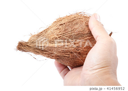 Coconut in hand isolated on white background Coconut in hand isolated on white background 41456952