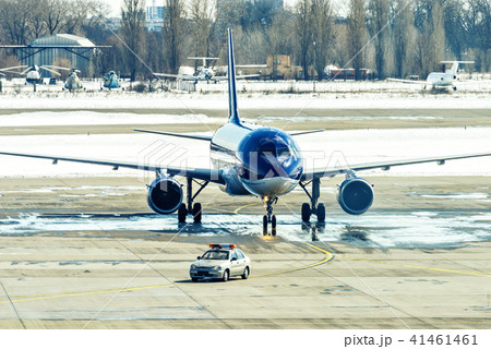 Unbranded blue plane taxiing after follow me car Unbranded blue plane taxiing after follow me car 41461461