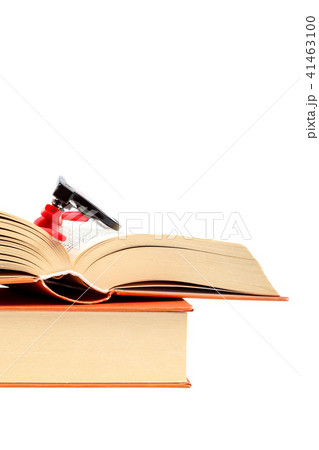 Open book and glasses on a stack of books 41463100