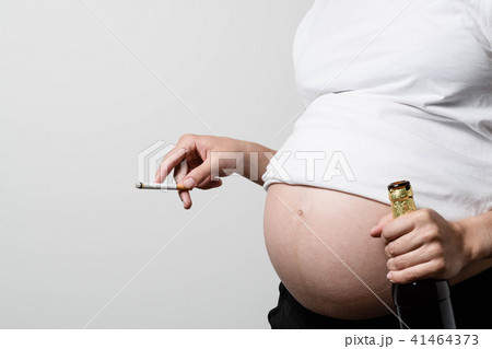 Pregnant woman with beer and cigarette 41464373