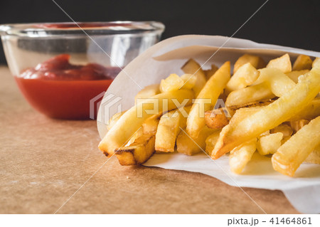 French fries with ketchup on wooden table. 41464861