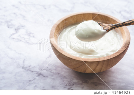 Yogurt in wooden bowl on marble table 41464923
