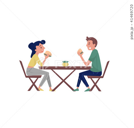 Young couple sitting behind wooden table and eating tasty burgers. Lunch time. Fast food theme. Flat 41469720