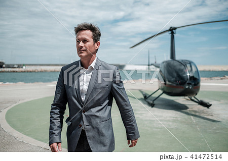 Businessman near private helicopter 41472514