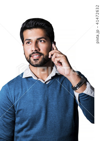 Smiling man standing in sweater with smart phone Smiling man standing in sweater with smart phone 41472632
