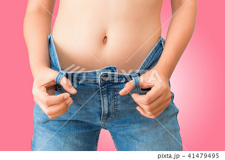 Young woman showing successful weight loss  41479495