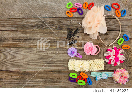 Different hair clips on wooden background  41486025