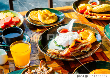 Healthy breakfast set with egg bacon pancakes orange juice milk bread and coffee 41486885