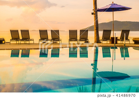 Beautiful outdoor view with umbrella and chair around swimming pool in luxury hotel and resort 41486970