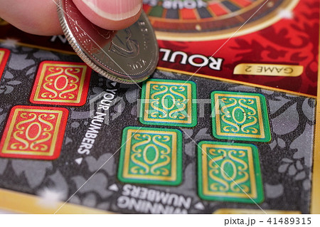 Woman scratching lottery ticket. Woman scratching lottery ticket. 41489315