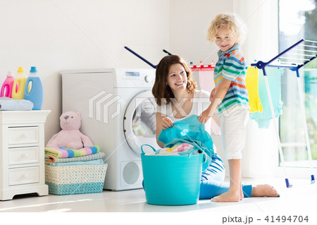 Family in laundry room with washing machine 41494704