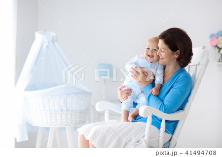 Mother and baby at home. Mom and child in bedroom. 41494708