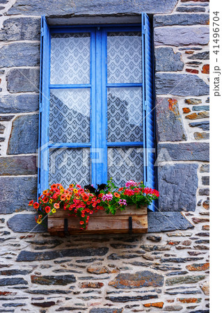 Flower pot placed at the window of old house 41496704