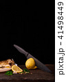 Cutted lemonwith black knife  41498449