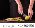 Unrecognizable woman cutting fresh lemon 41498450