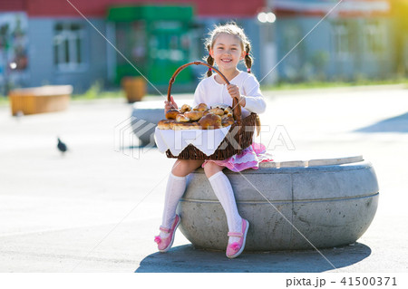 Little girl with a basket of bread. Little girl with a basket of bread. 41500371