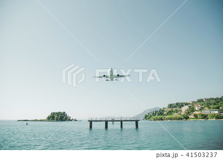 the plane is landing to the airport of Corfu at summer day 41503237