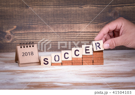 soccer and 2018 paper calendar. Wooden letters on the office desk 41504103