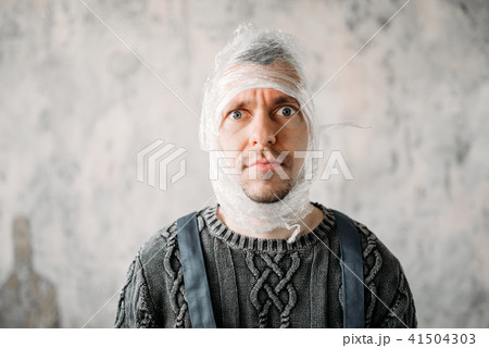 Autist with stretch film on head, autism Autist with stretch film on head, autism 41504303