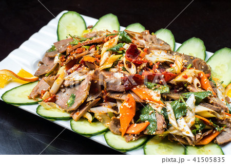Chinese cuisine, boiled beef with cucumber and tomato in white plate, on black background 41505835