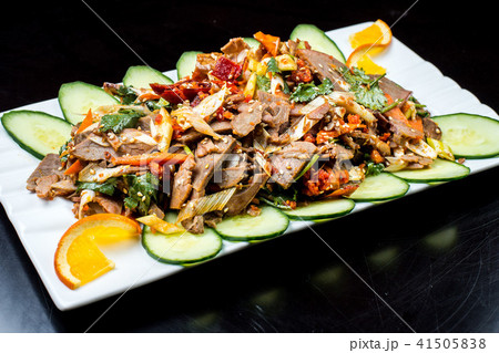 Chinese cuisine, boiled beef with cucumber and tomato in white plate, on black background Chinese cuisine, boiled beef with cucumber and tomato in white plate, on black background 41505838