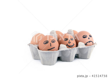 Close-up view of raw chicken eggs with a smile in box on white background Close-up view of raw chicken eggs with a smile in box on white background 41514738