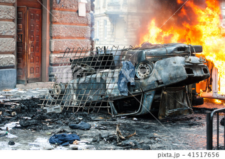 burning car. car destroyed and set on fire during the riots. city center burning car. car destroyed and set on fire during the riots. city center 41517656