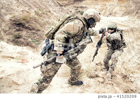 American commando helping friend to climb on dune American commando helping friend to climb on dune 41520209