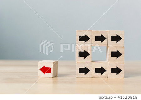 Wooden block with red arrow facing the opposite 41520818