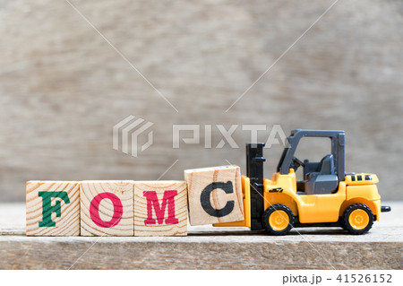 Toy forklift hold letter block c in word FOMC Toy forklift hold letter block c in word FOMC 41526152