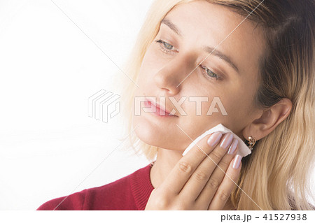 Woman Cleaning Face with white cotton pad. Woman Cleaning Face with white cotton pad. 41527938