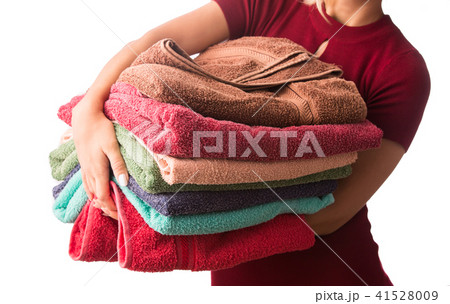 Woman holding stack of clean laundry towels. Woman holding stack of clean laundry towels. 41528009