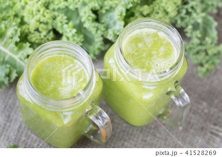 Nutritional smoothie of fresh organic curly green kale with tang Nutritional smoothie of fresh organic curly green kale with tang 41528269