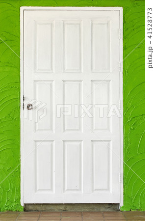 white wooden door in green concrete wall 41528773