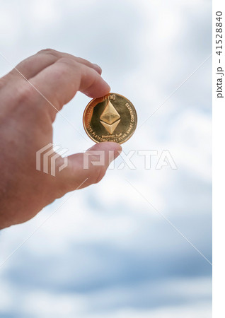 Ethereum coin in hand 41528840
