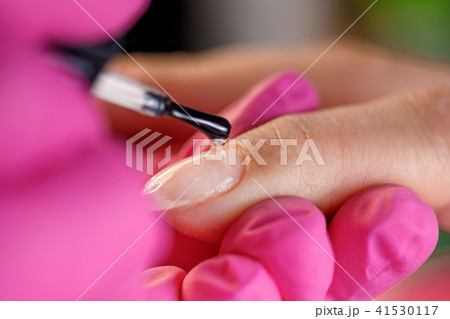 beautician applying Polish nails beautician applying Polish nails 41530117