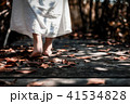 woman in white dress walking barefoot on wooden 41534828