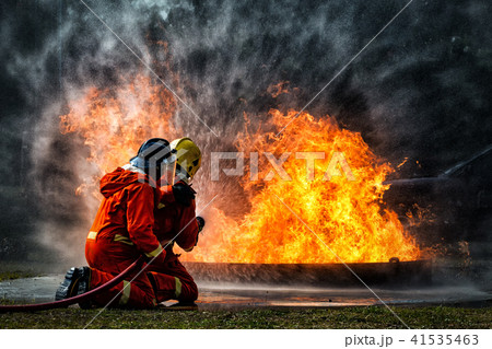 fireman using water fighting with fire flame 41535463