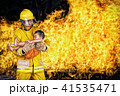 fireman save a child from fire incident. 41535471