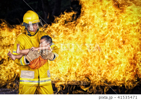 fireman save a child from fire incident. 41535471