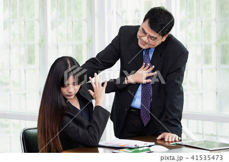 Man molesting women employee in the office. 41535473