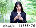 woman watching her photos on cellphone 41535476