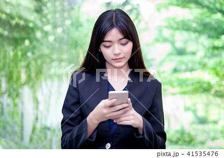 woman watching her photos on cellphone 41535476