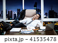 businessman sleeping on couch  in office 41535478