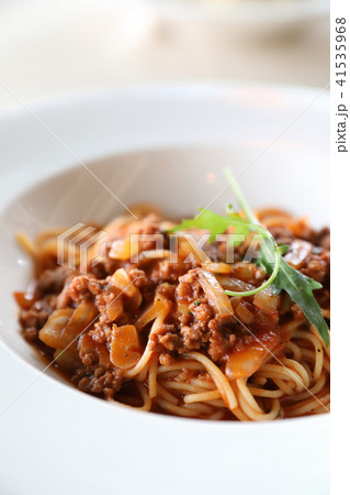 spaghetti Bolognese with minced beef and tomato sauce garnished with parmesan cheese and basil , Italian food spaghetti Bolognese with minced beef and tomato sauce garnished with parmesan cheese and basil , Italian food 41535968