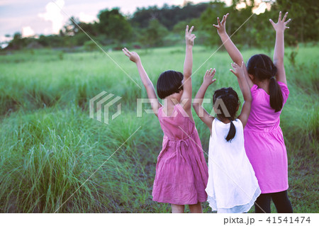 Asian children raise hands and playing together Asian children raise hands and playing together 41541474