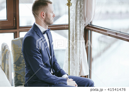elegant groom in a hotel room 41541476