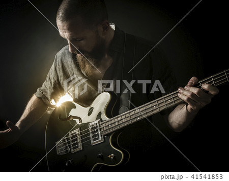 Bearded man playing bass guitar Bearded man playing bass guitar 41541853